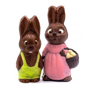 chocolate girl bunny in a pink dress and a chocolate boy bunny with green shorts