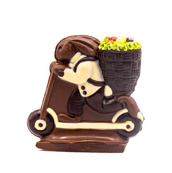 milk chocolate bunny with a basket on his back riding a scooter
