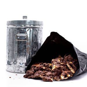 mini trash can with plastic bag filled with chocolate covered candies