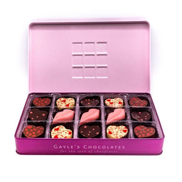 pink metal tin with 12 candies shaped like hearts and lips