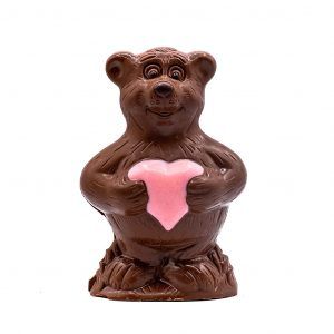 chocolate shaped like a bear holding a pink candy heart