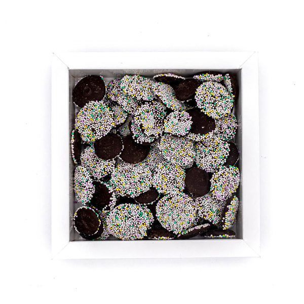 box of small chocolate rounds with candied sprinkles in white, yellow and green