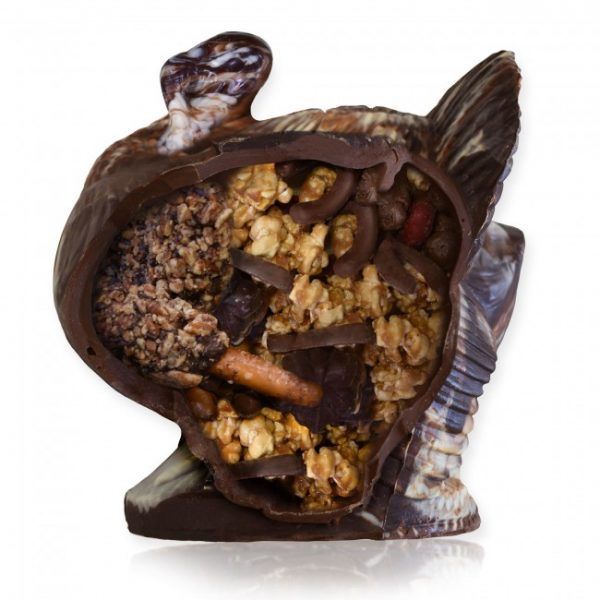 Chocolate turkey cut in half showing assorted candies and nuts inside it
