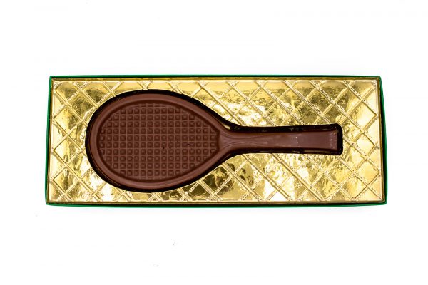 chocolate candy shaped like a tennis racket in a box with gold foil